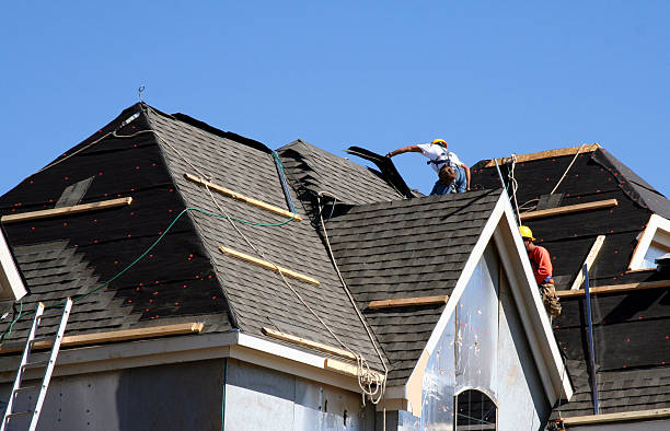 Roofers in action replacing tudor style roof